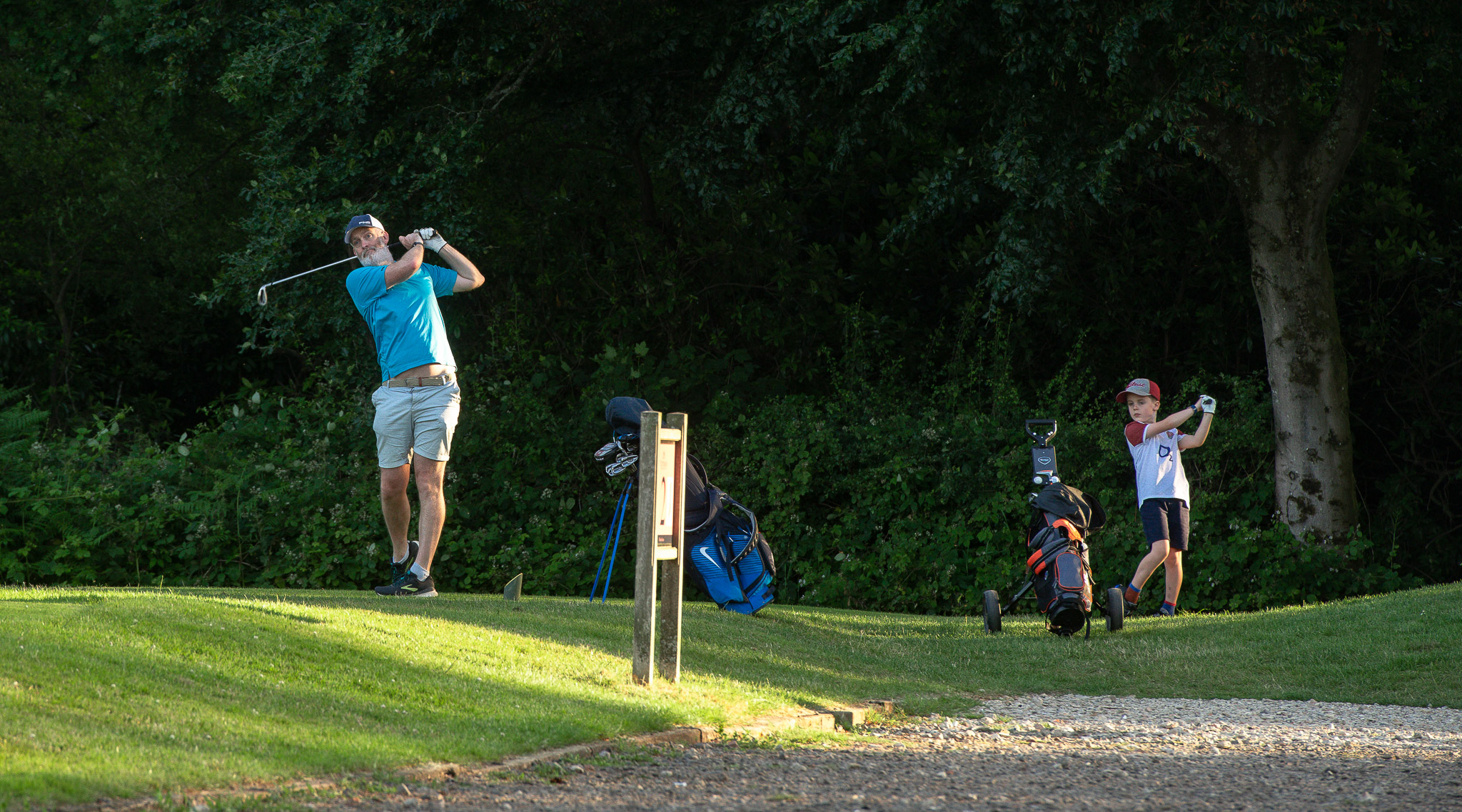 Father and son playing golf