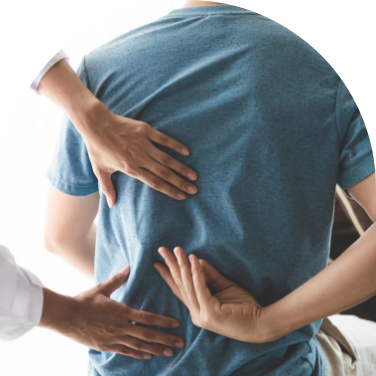 Three hands pressing on a man's back to relieve pain.