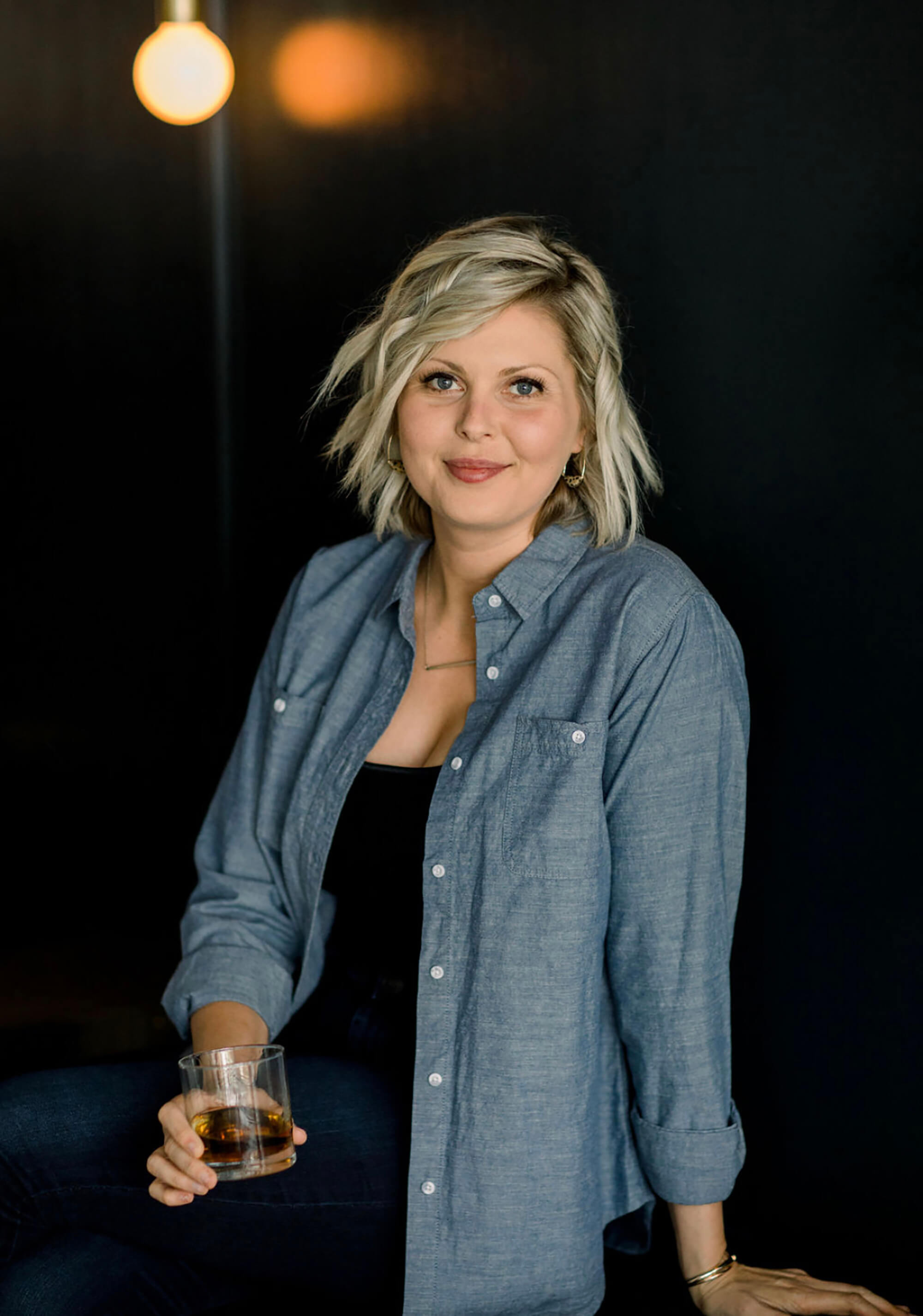 Master Distiller, Marianne Eaves, holding a glass of rum