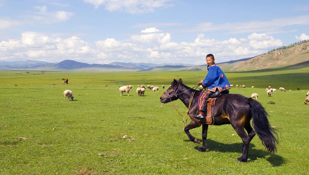 boy riding horse in Mongolia.