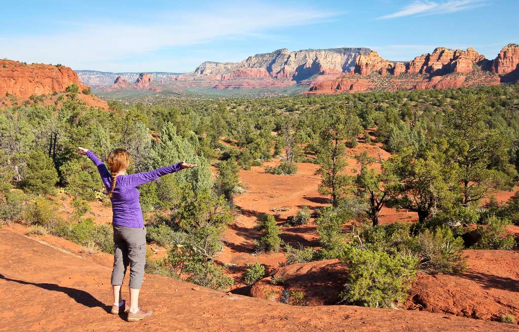 Person overlooking Sedona landscape.