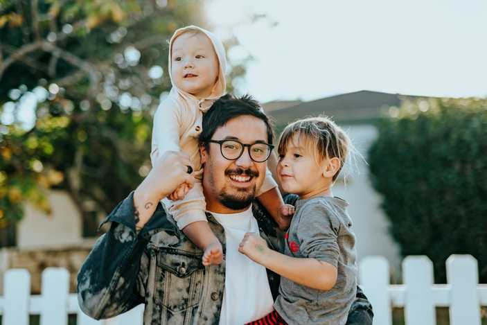Baby sitting on dads shoulders