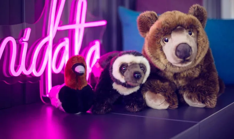 Funidata neon sign saying wearefunidata with teddybears next to it