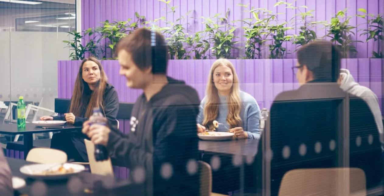 Four colleagues in the lunchroom at the Funidata office