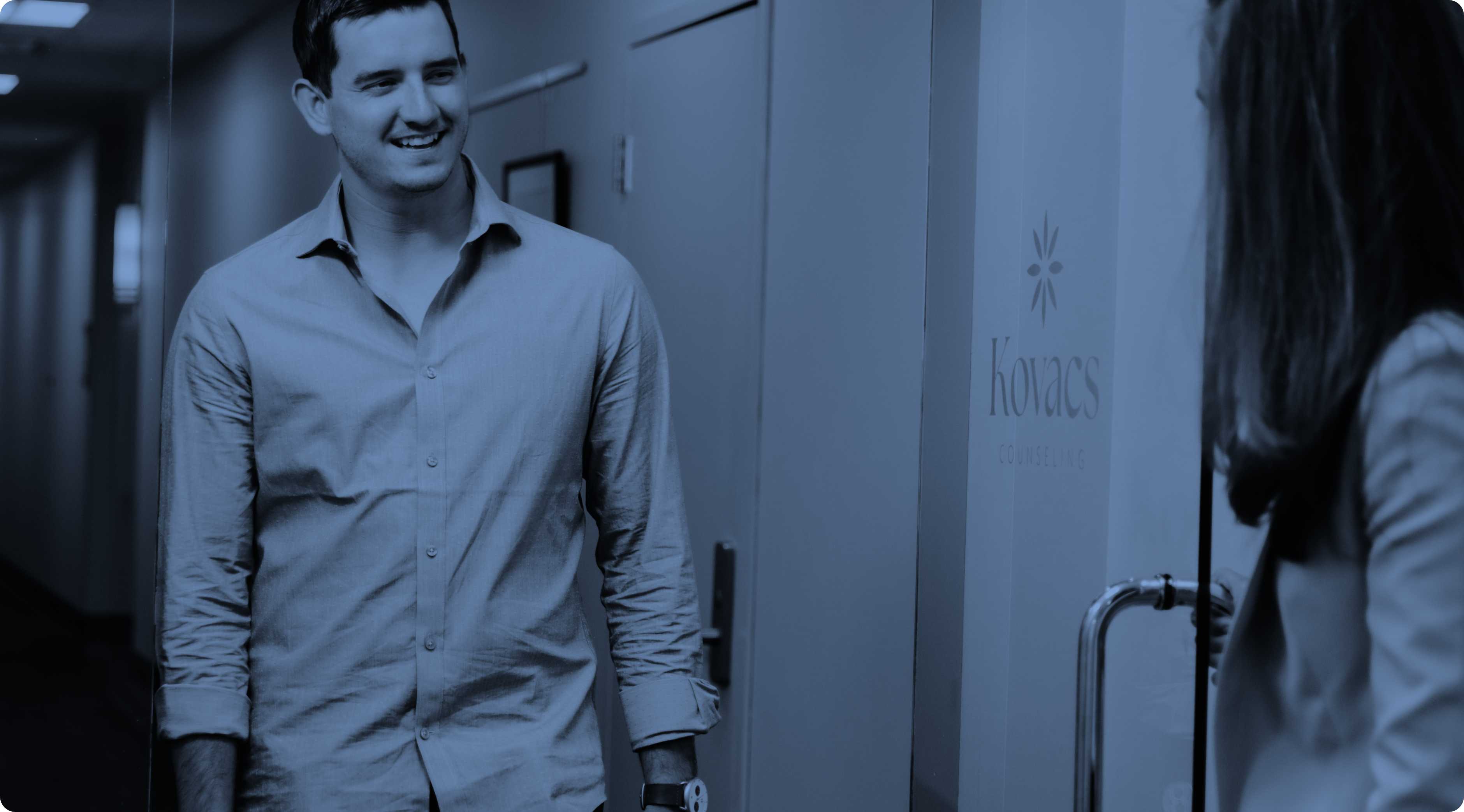 Katie Kovacs greeting a male client walking in