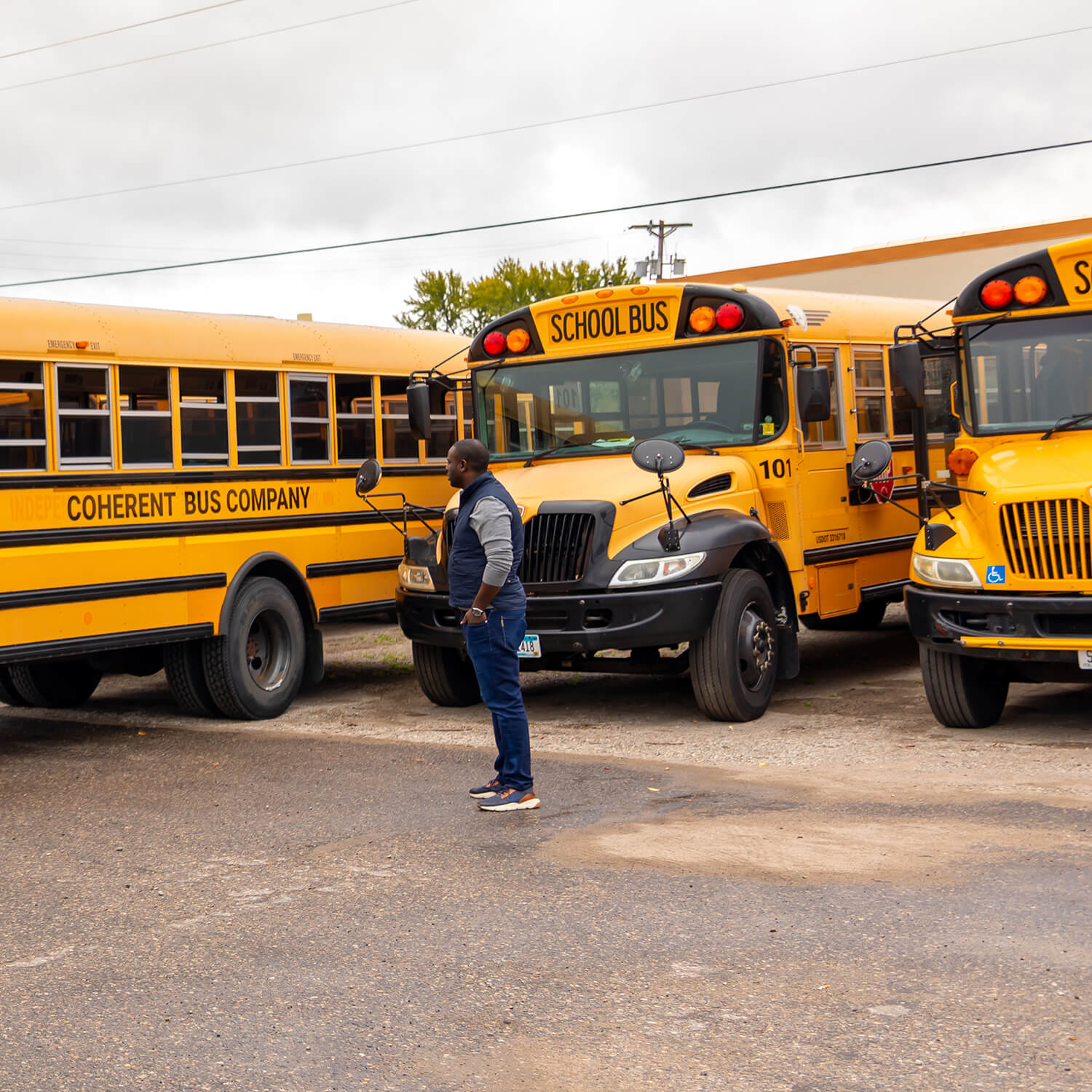 Sacad Guled in front of a Coherent Bus Company bus