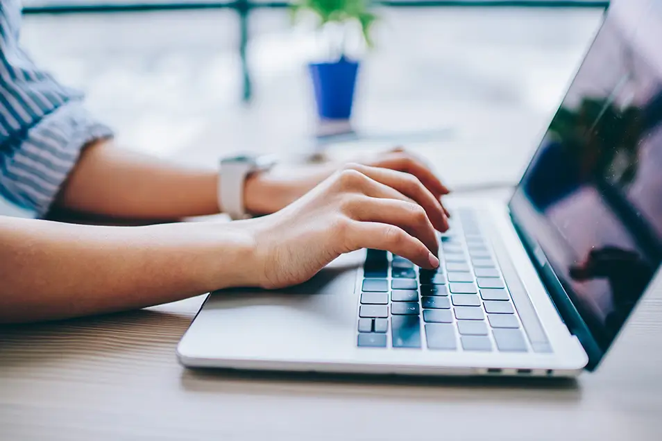 Person typing on a MacBook Pro.