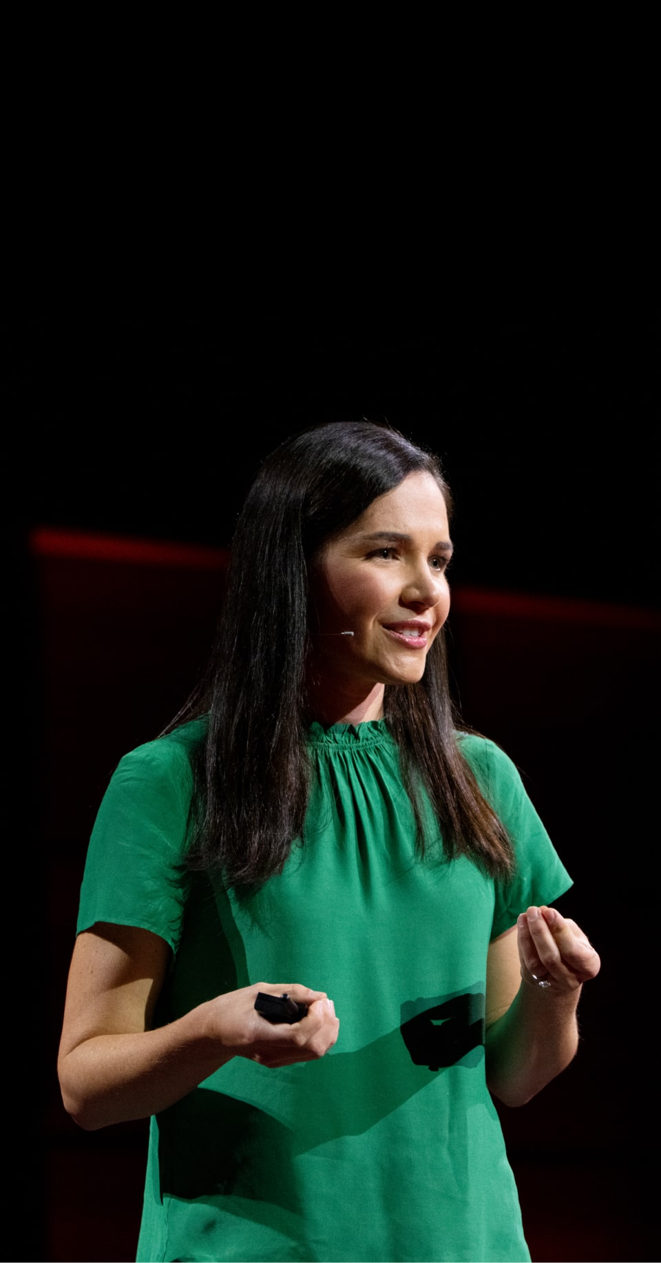 A woman leads a TED Talk.