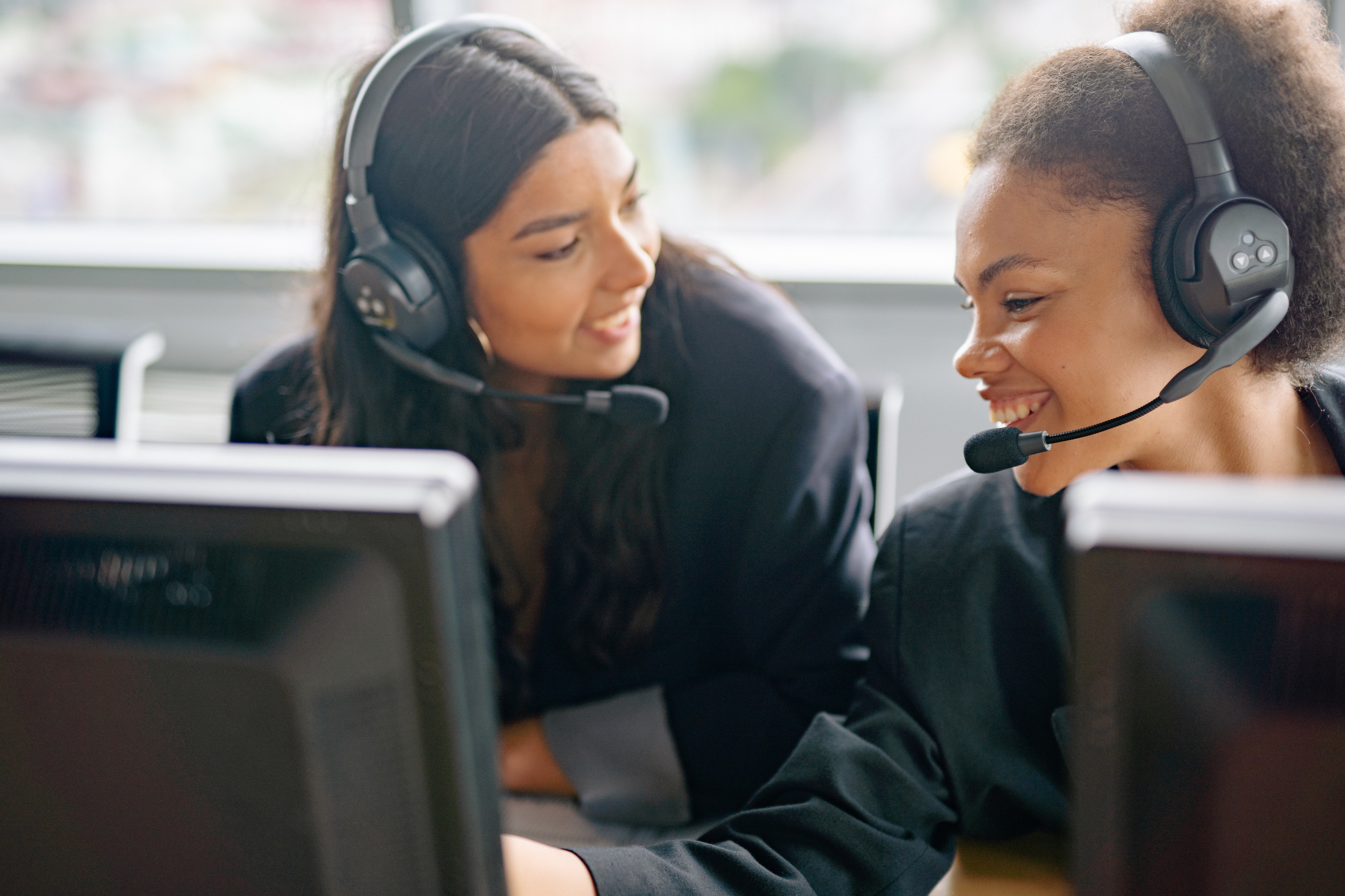 Two customer service representative speak positively at work.