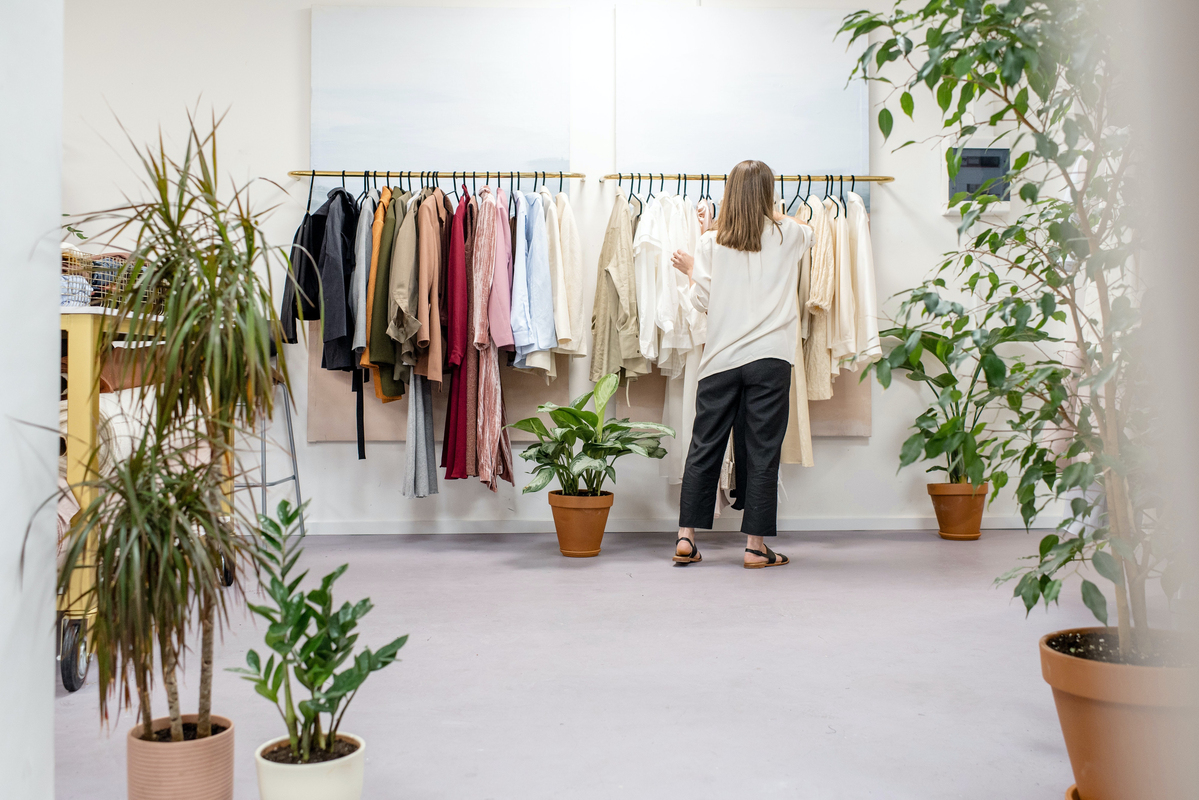 Person adjusting clothes on the rack