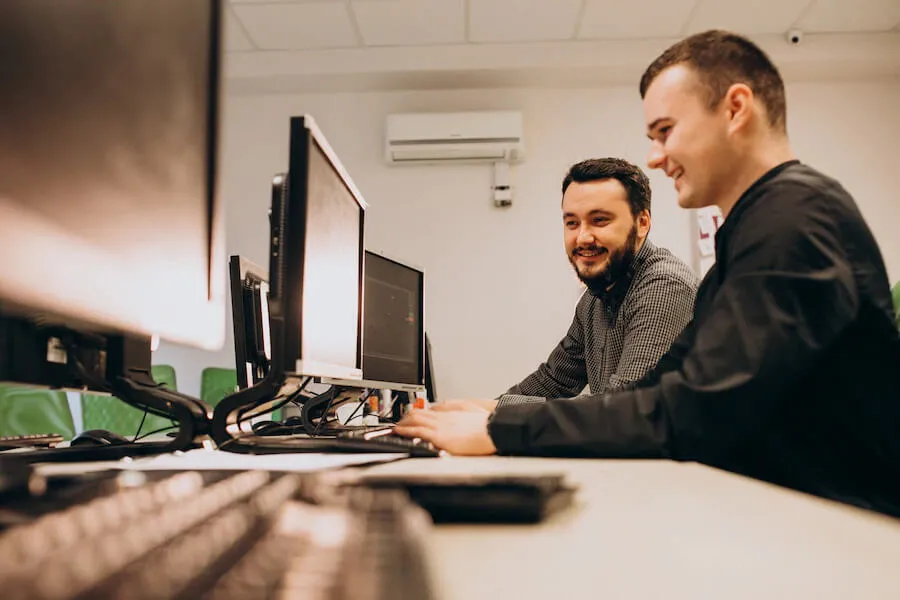 two man looking a monitor