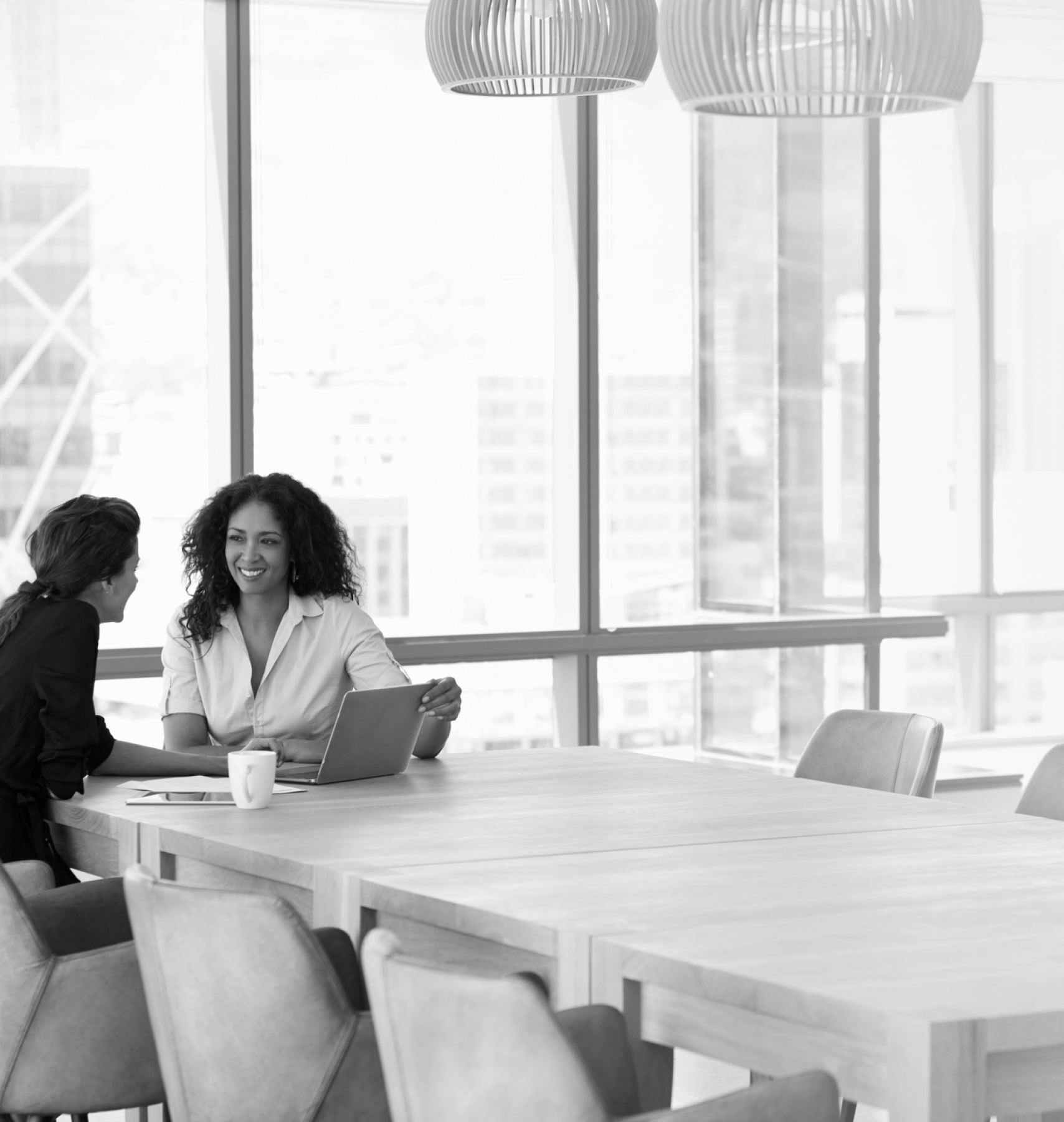 Two women in the office chatting