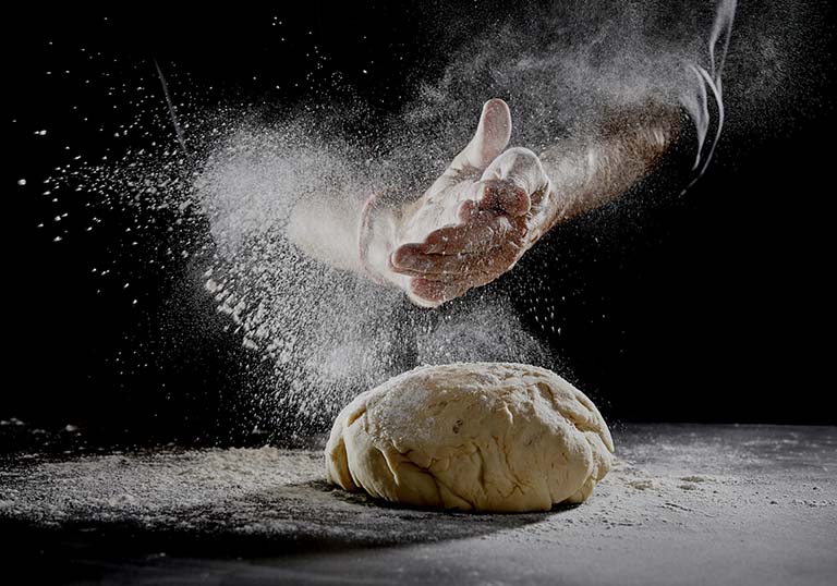 man kneading a dough