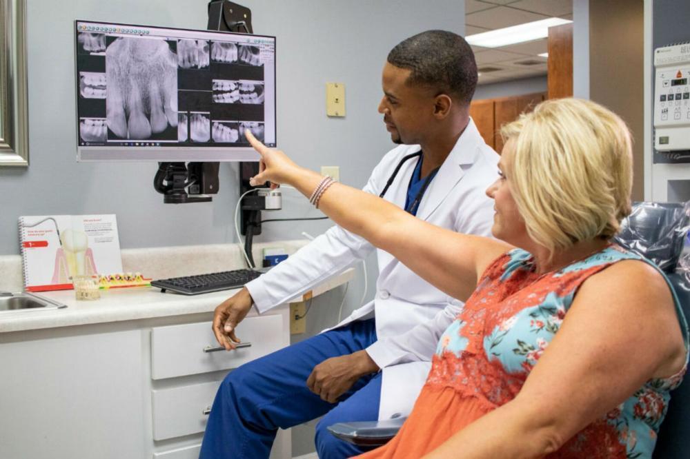 Dr. King showing a digital dental xray to a patient