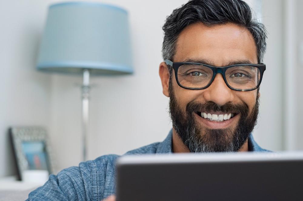 man smiling while working at the computer