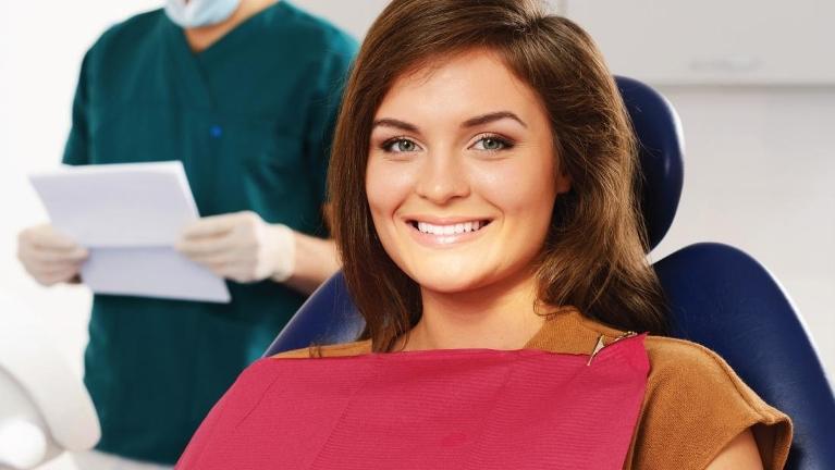 Woman at dentist after tooth extraction in huntsville al