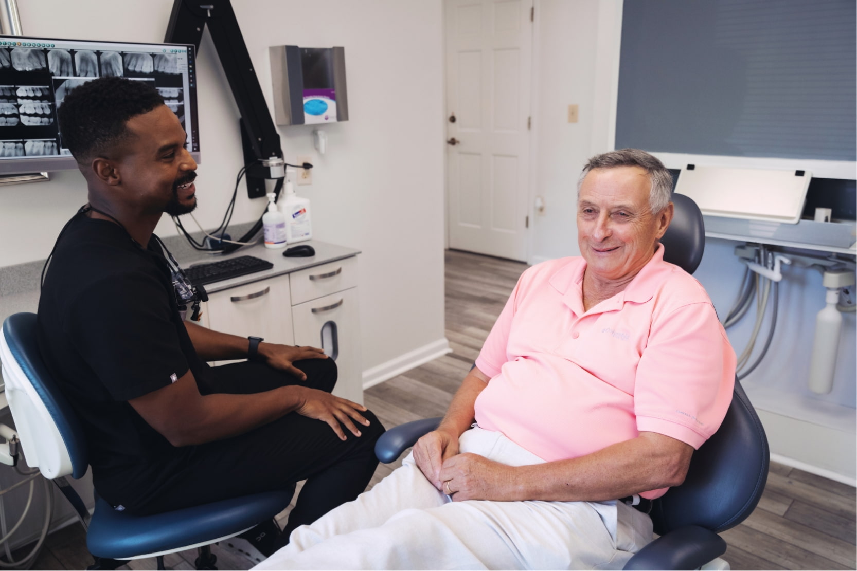 Dr. King laughing with an elderly patient