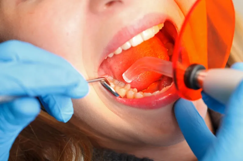 A patient getting checked by a dentist for gum disease.