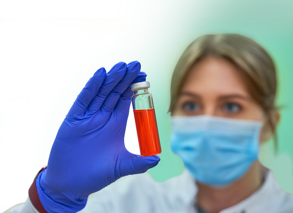 A scientist looking at the CBD sample in a vial.