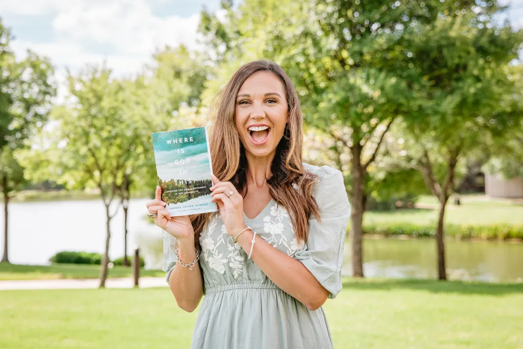 Landra holding her book "Where Is God In This"