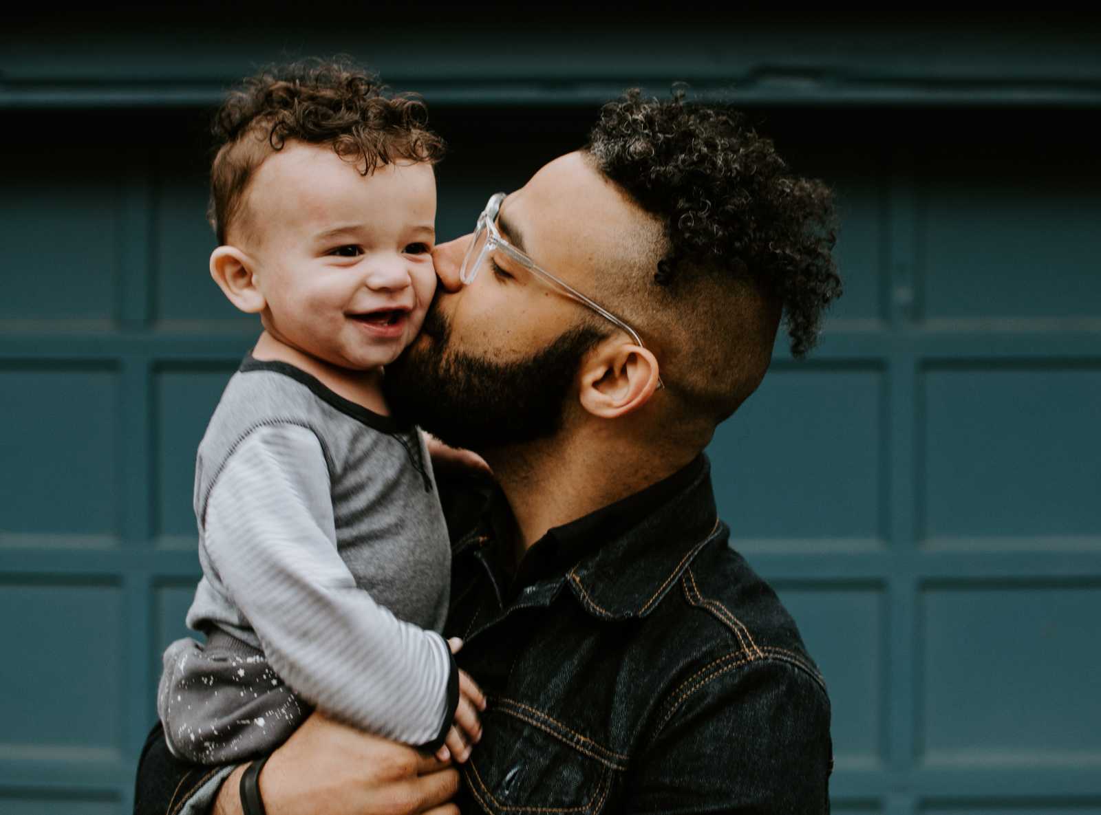 Father holding and kissing his son on the cheek
