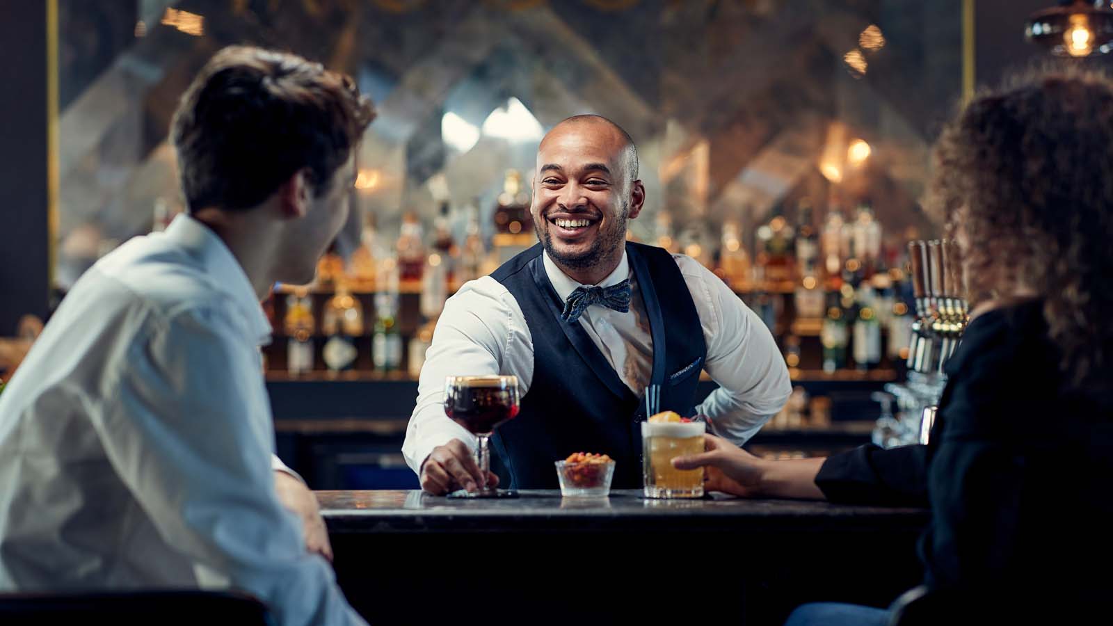 Our work for Van der Valk Hotels (couple enjoying a talk and cocktails at the hotel bar)