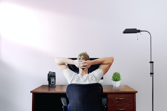 man sitting looking at monitor