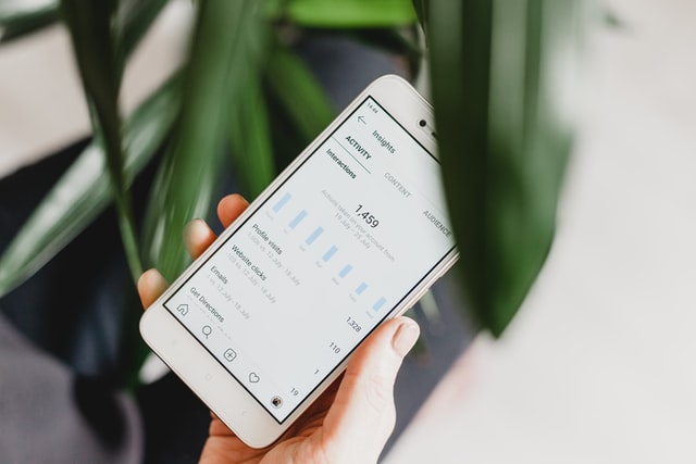 phone showing social media metrics
