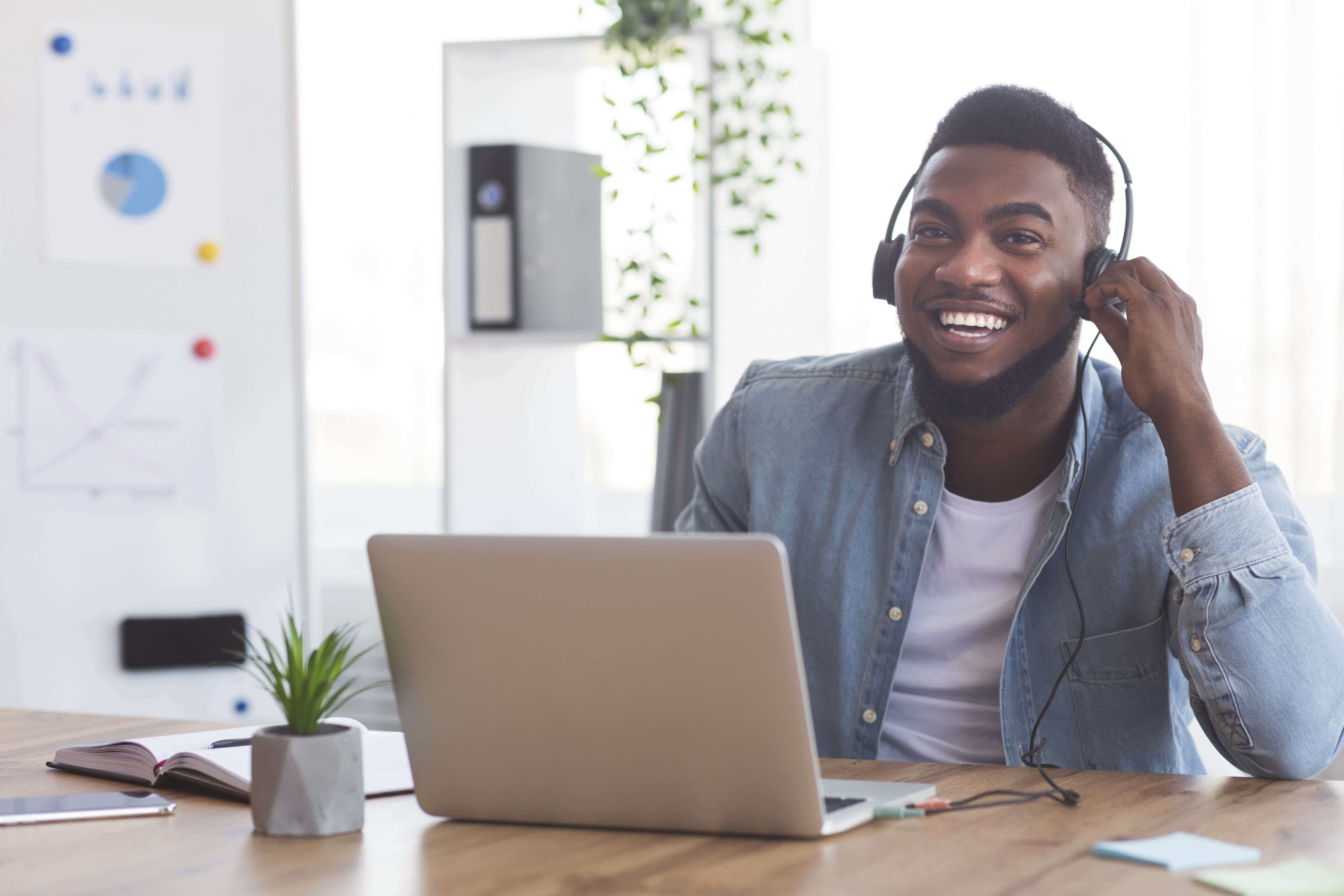 man using laptop and smiling