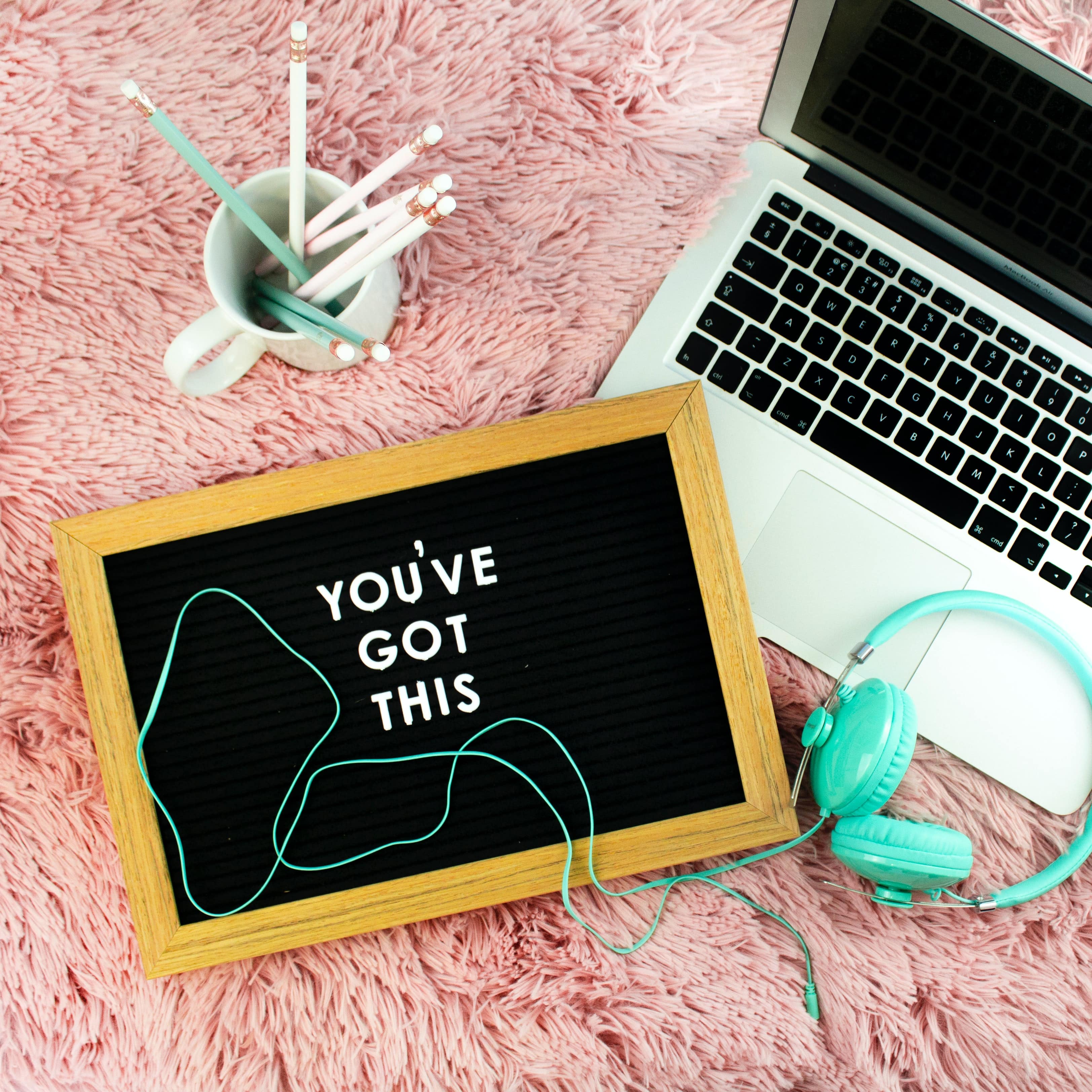 laptop and a sign that says "You've got this"