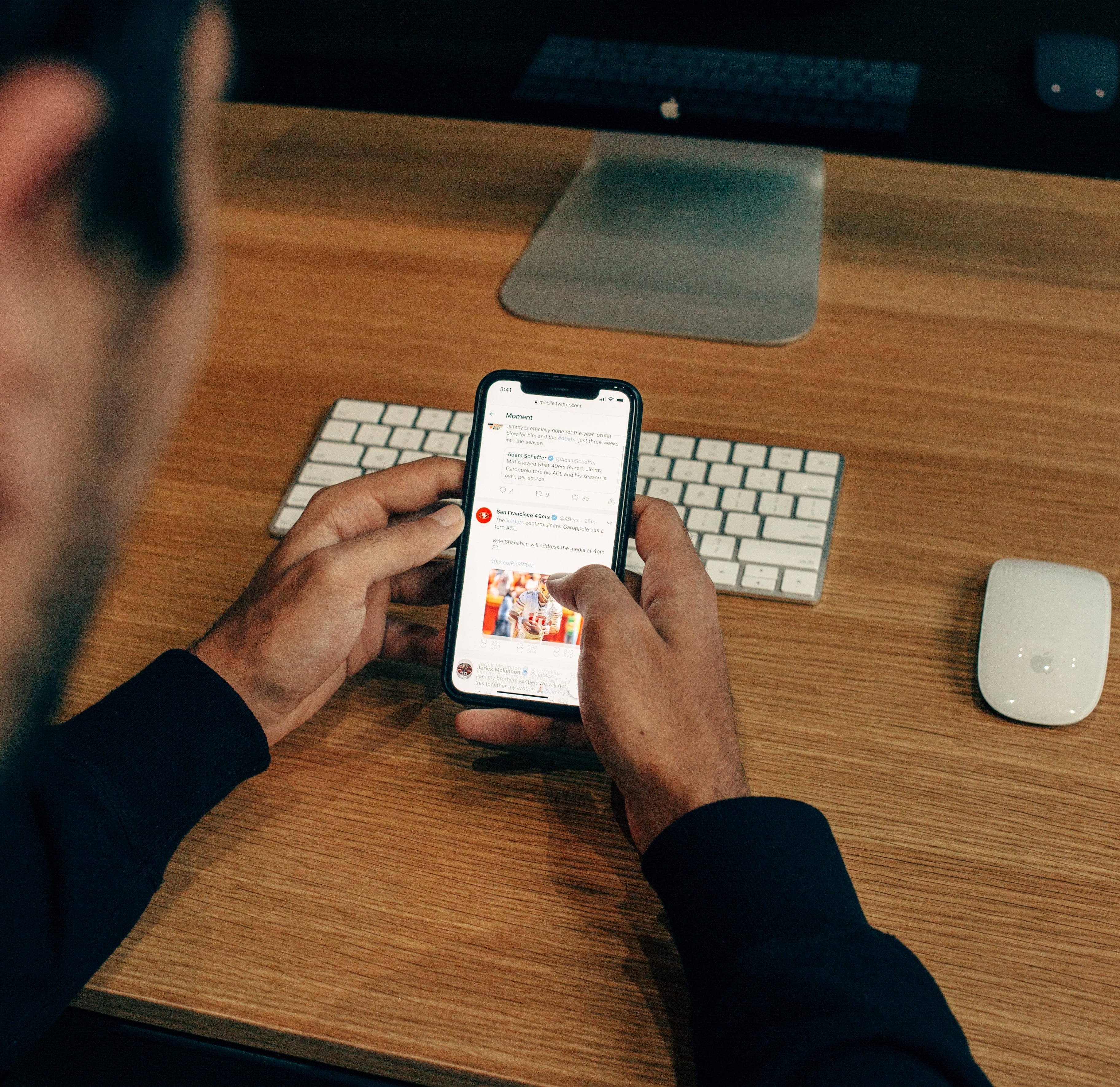 man holding phone using a social media platform