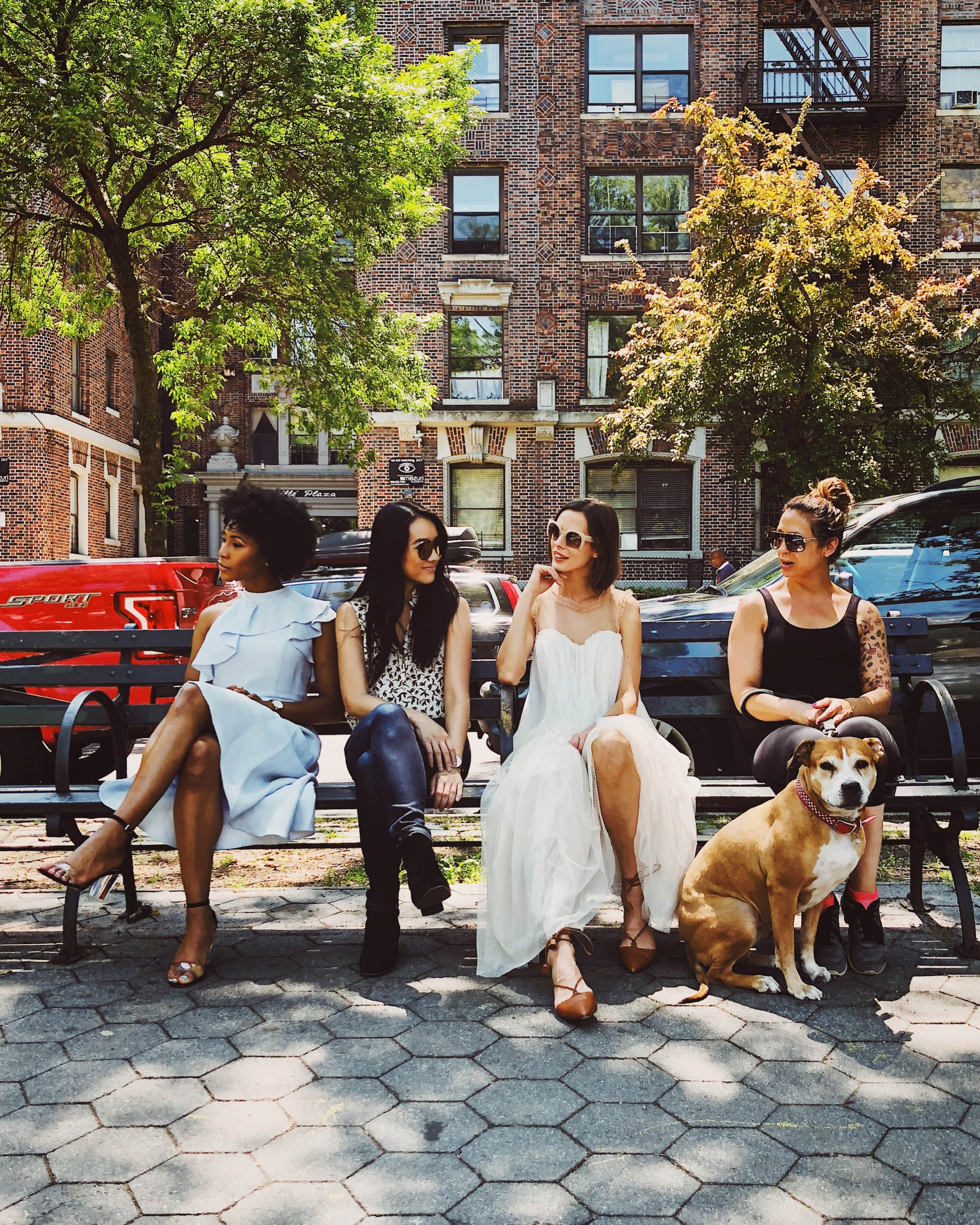 group of women sitting on a bench