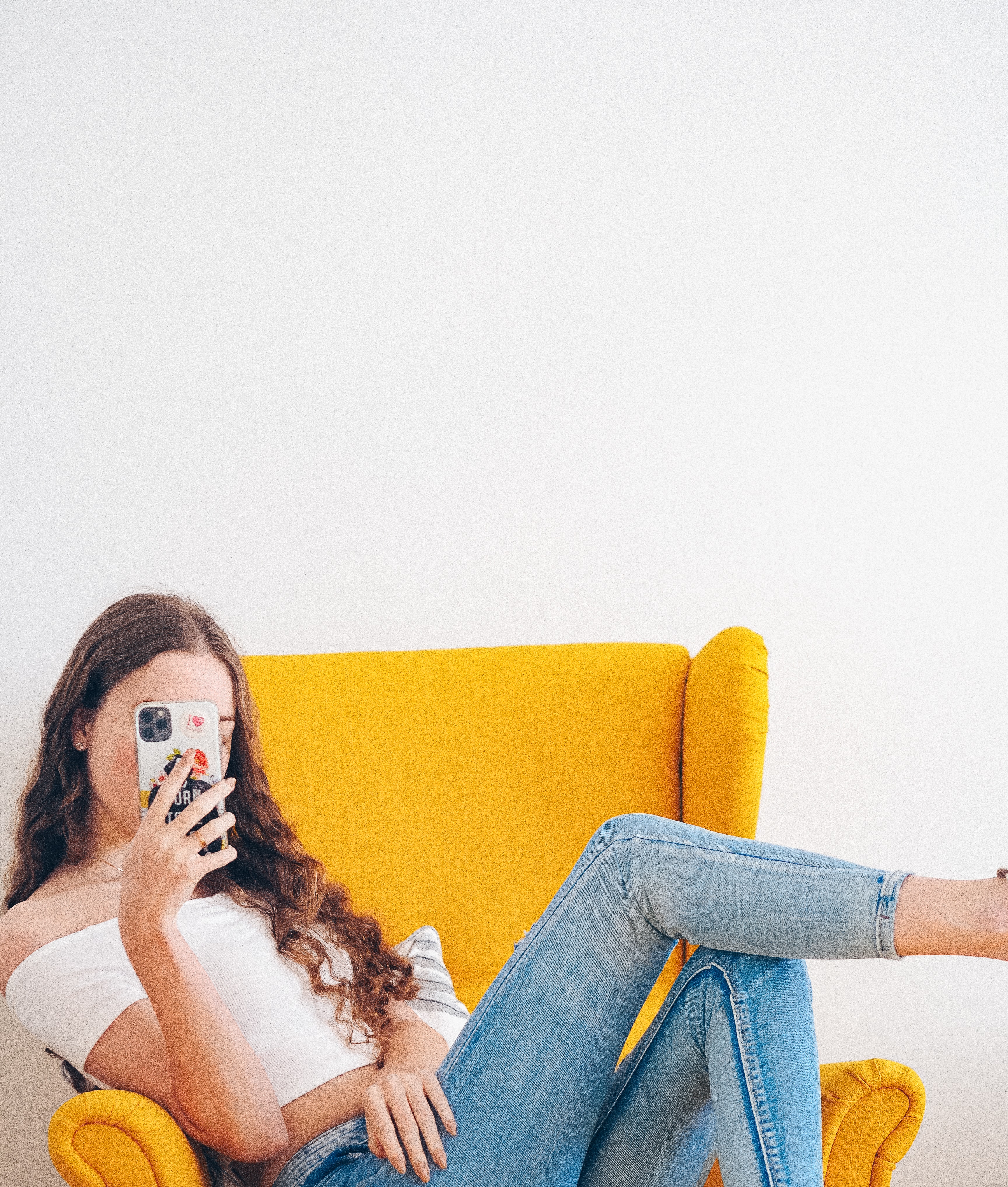 woman using her phone on a couch