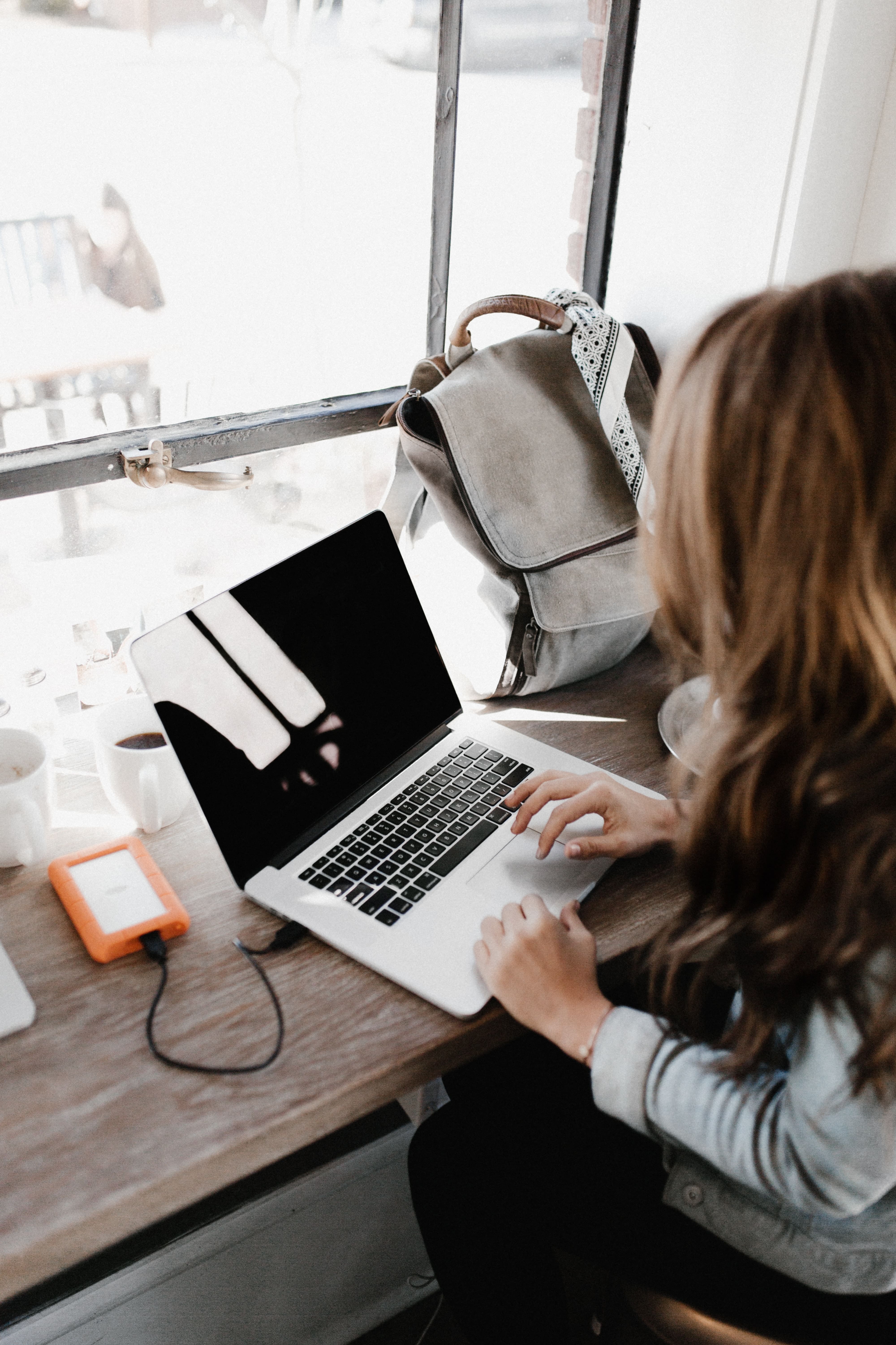 woman writing on her laptop