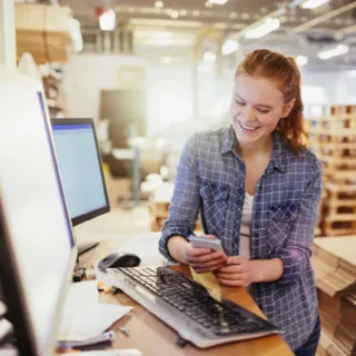 Woman happily checking her phone