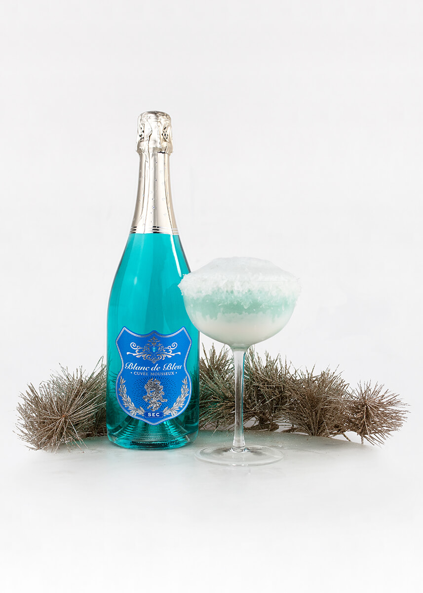 A "Bleu Frost" cocktail with pine needles and a bottle of Blanc de Bleu Sec.