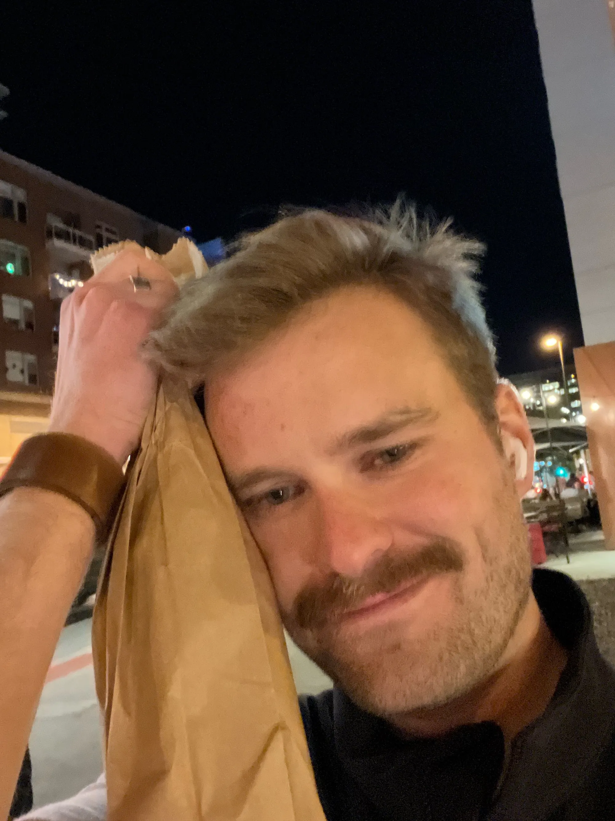 Mason Maughan hugging a bottle of wine wearing his Sicily bracelet