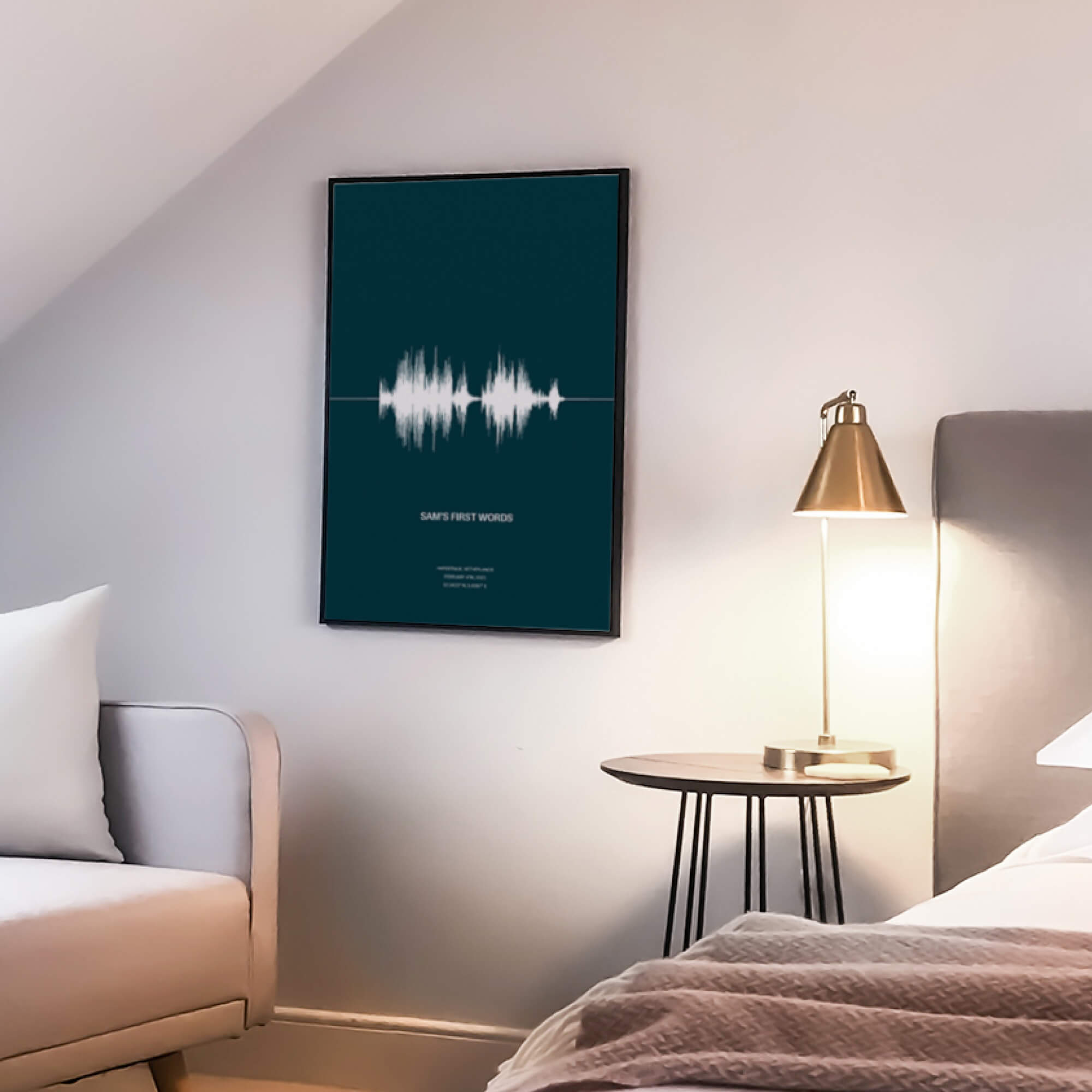 A teal poster inside a black frame. The poster depicts a sound-wave of a child's first words. And includes an audio caption, location and date of the recording.