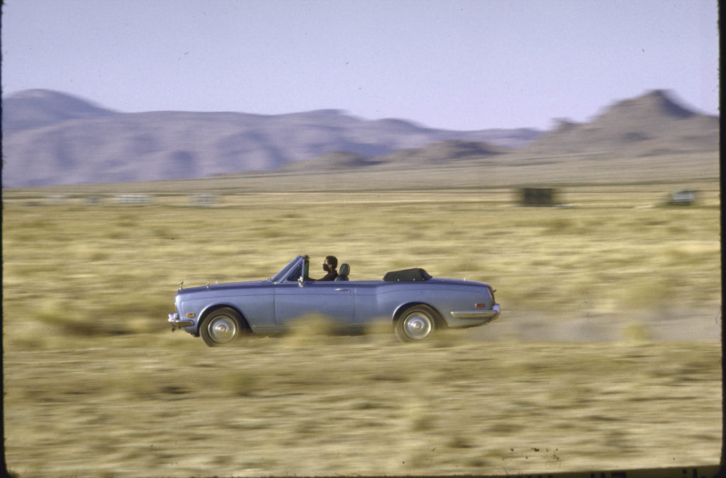 A car driving in the desert.