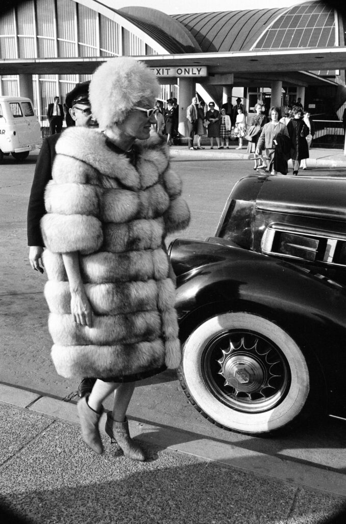 Phyllis Diller in a fur coat.