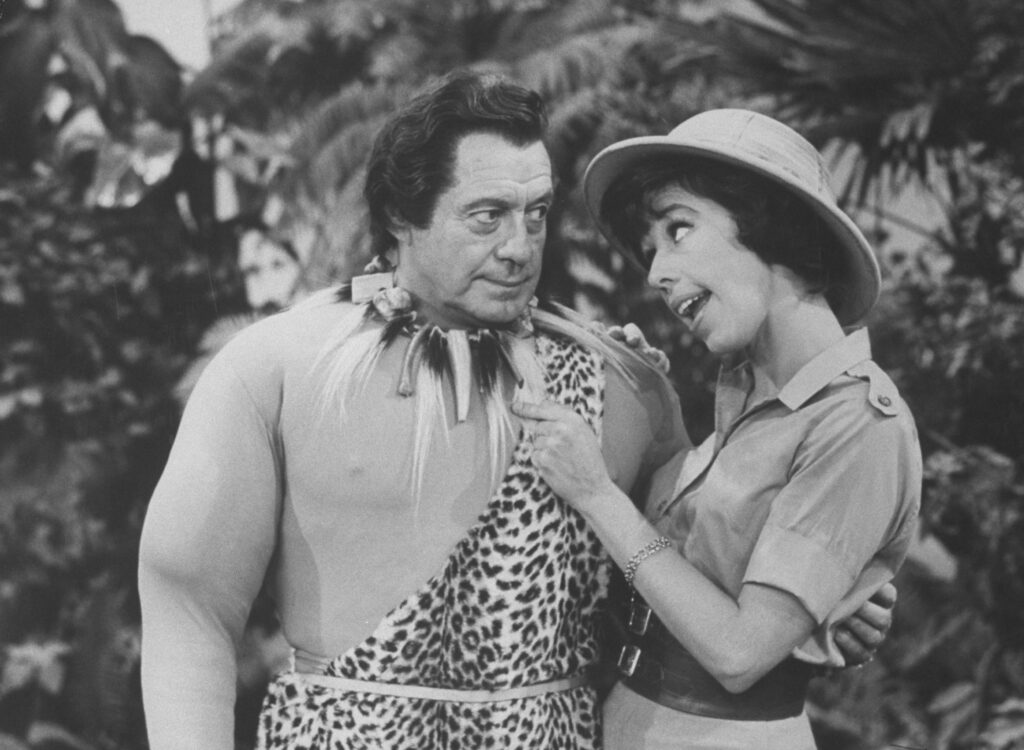 Jack Benny and Carol Burnett performing a comedy skit.