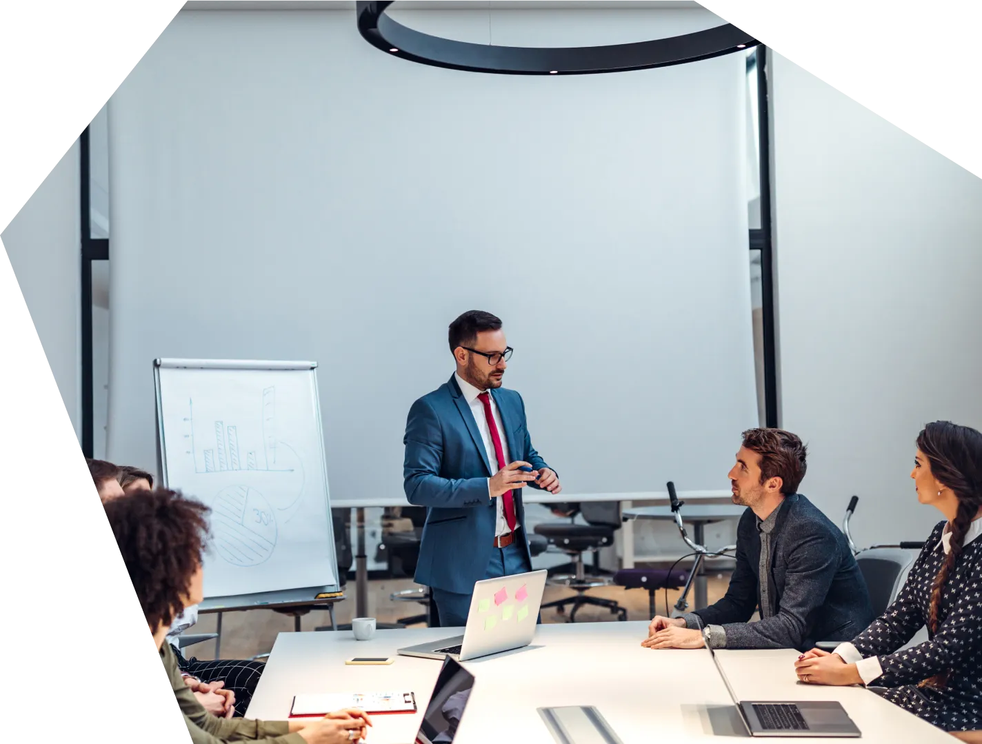 A corporate meeting with a person explaining their work to a group