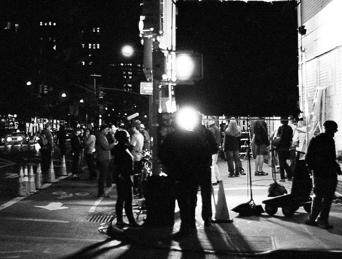film crew working on set at night