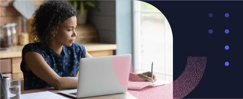 A woman takes notes while researching on her laptop how to request a bank reference letter.