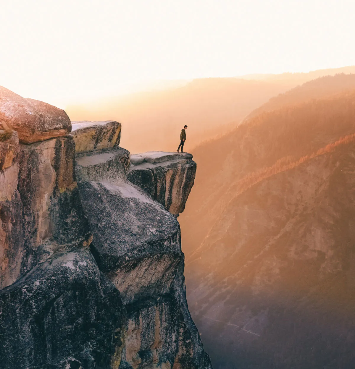 Man standing on edge of cliff